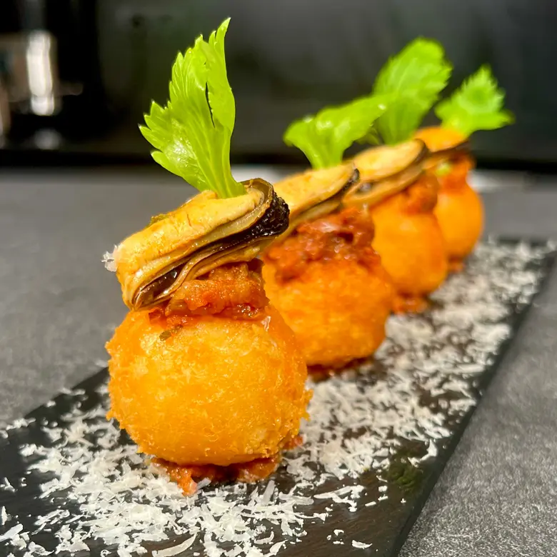 creation thumb for Parmesan Bites with Mussels & Sun-dried Tomato Sauce