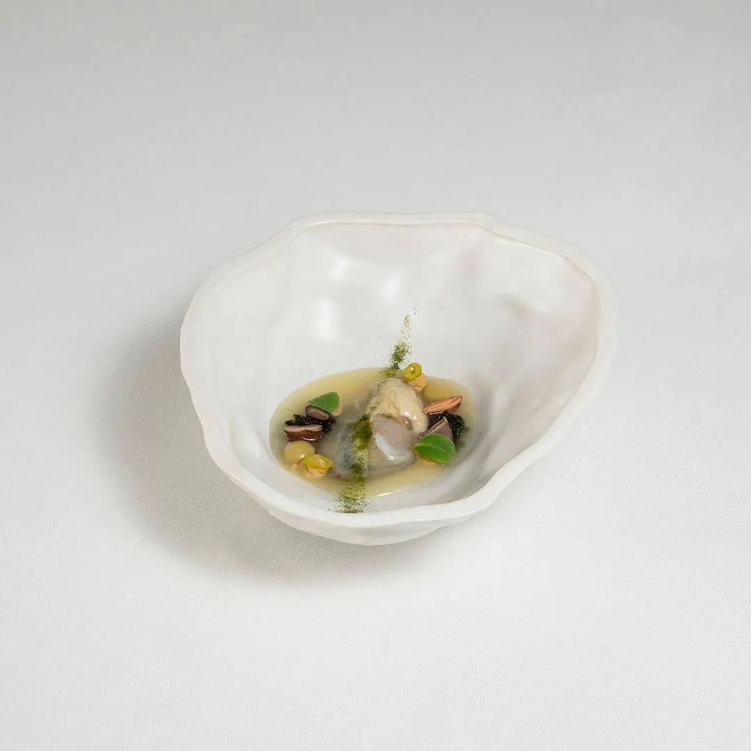 creation thumb for Oyster, oyster & piparra water juice, olive sphere, barnacle