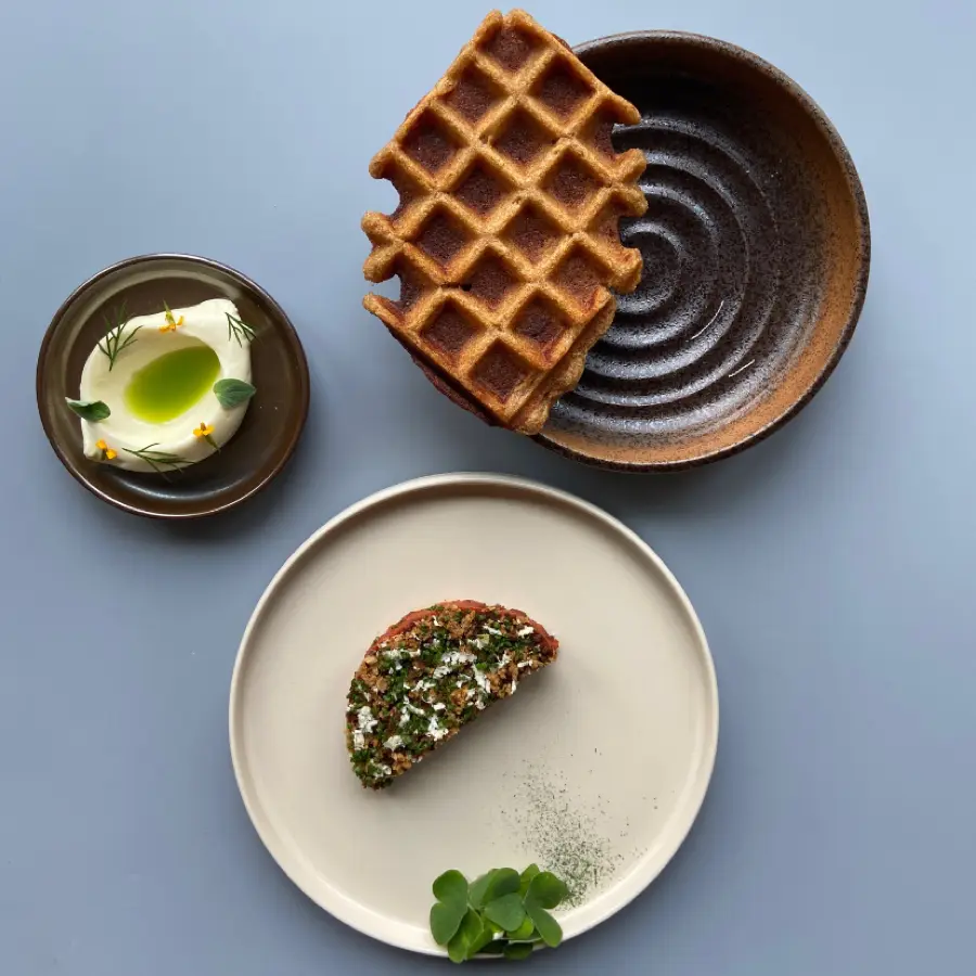 creation thumb for mushroom tatar with horseradish,crispy onions and a waffle made of koji flour, topped with vegan miso butter
