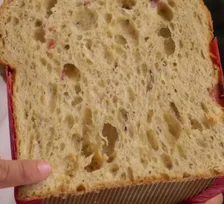 A slice of white chocolate and berries panettone