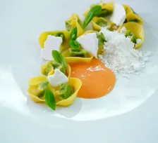 A plated dish garnished with small violet flowers
