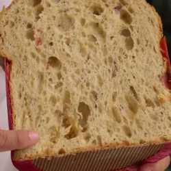 A slice of white chocolate and berries panettone