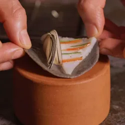 Hands folding a taco filled with squid