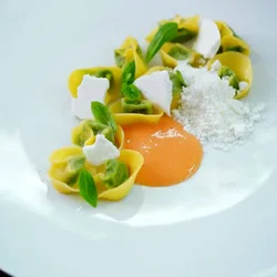 A plated dish garnished with small violet flowers