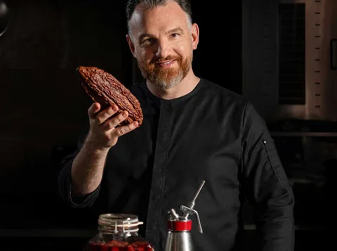 René Frank, owner of CODA Berlin, with plated chocolate desserts